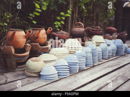 Cheap ceramic cups, plates and bowls basket on a street market for sale in Vietnam Stock Photo