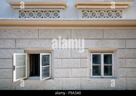 Two windows on a brick wall Stock Photo