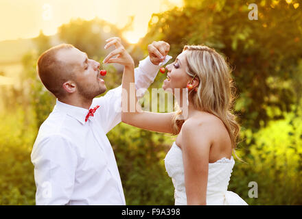 Happy bride and groom enjoying their wedding day in green nature Stock Photo