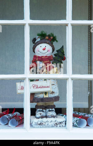 Christmas snowman in a window. Castle Combe, Wiltshire, Cotswolds. England Stock Photo