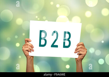 B2B (marketing) card in hand with abstract light background. Selective focus. Stock Photo
