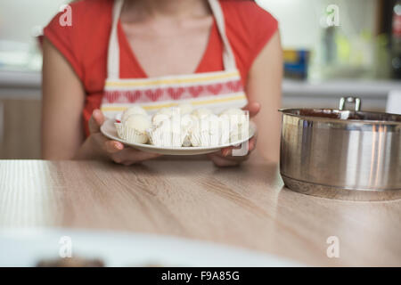 Woman is making christmas cakes in the kitchen Stock Photo