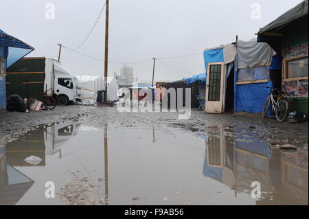 View of flooded roads and makeshift shelters in the Jungle refugee camp, Calais. Conditions at the refugee camp, home to 6,000 people, have got worse at the winter and rain have set in. Stock Photo