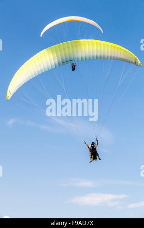 Burgas, Bulgaria - July 23, 2014: Amateur paragliders in blue sky with clouds, vertical photo Stock Photo