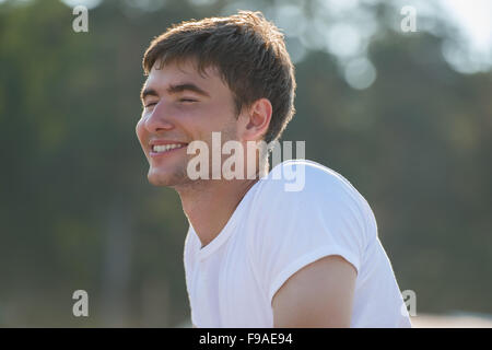 Young man with pure happiness on his face admiring sun Stock Photo