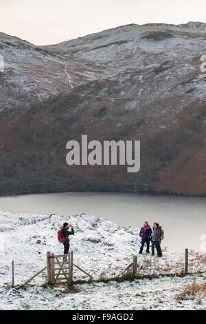 People taking a photo of themselves whilst walking in winter in snow bu Ullswater in the Lake District UK Stock Photo