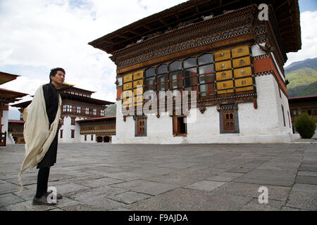 A Bhutanese man in traditional dress inside a fort Stock Photo