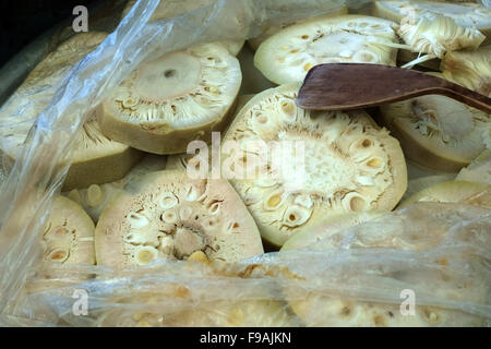 Young jackfruit or jakfruit sections for sale on a stall in a Bangkok wet food market, Thailand Stock Photo