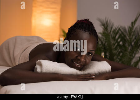 Spa African Woman in Beauty Salon Relaxing Stock Photo