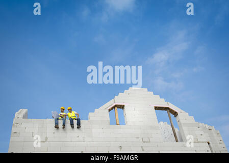 Construction Contractors building a big new home Stock Photo