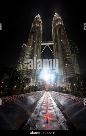 Fountain in front of illuminated Petronas Towers at night, Kuala Lumpur, Malaysia Stock Photo