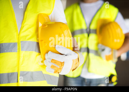 Construction workers collaborating on new house building Stock Photo