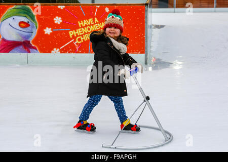 Glasgow, Scotland, UK. 15th Dec, 2015. Glasgow's annual  'Christmas on Ice' spectacular outdoor ice rink in George Square in the city centre attracts skaters of all ages and abilities. Those who are a little unsteady on the ice get a some help from parents and relatives. A fun way to have a break from Christmas shopping. Picture is of mollie Defalco, aged 4 from Glasgow. Credit:  Findlay/Alamy Live News Stock Photo