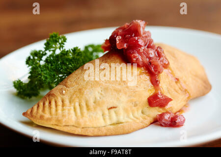 Lentil, Sweet Potato, Kale Handpie with Chutney Stock Photo