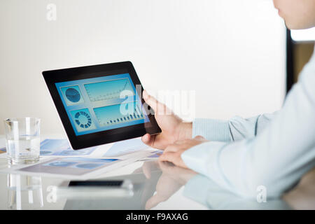 Businessman is reading business graphs and charts Stock Photo