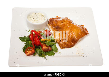 roasted chicken with vegetables on a white plate Stock Photo
