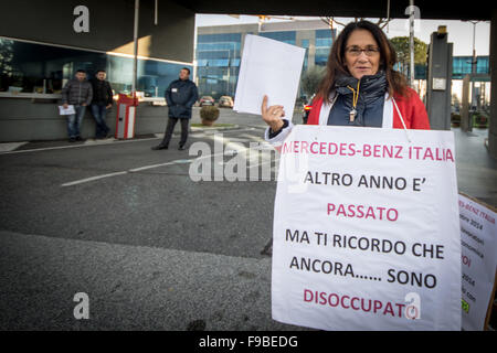 Rome, Italy. 15th Dec, 2015. The former employee of Mercedes Benz brings placard during a protest outside the Mercedes Benz factory in Rome to demand full reinstatement. The workers claim the growth in sales between 2013 and 2015 dispute the company's argument for redundancy. © Andrea Ronchini/Pacific Press/Alamy Live News Stock Photo