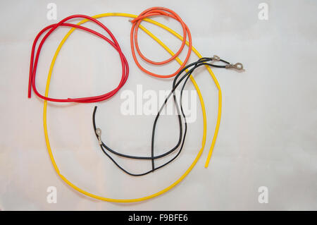Red, yellow and black wires on white background Stock Photo