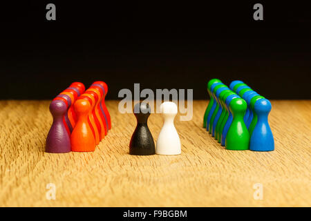 Concept for: marriage, bride, groom and guests. With black and white pawn in center and colorful pawn figures on the sides. Stock Photo