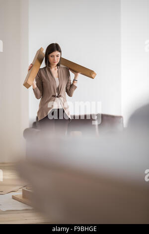 Young woman doing DIY repairs at home putting together self assembly furniture Stock Photo