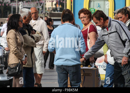 Pea men, peamen, shell men, con men, most of the people in this picture are part of the game to trap tourists in Benidorm Stock Photo