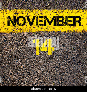 14 November calendar day written over road marking yellow paint line Stock Photo