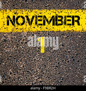 1 November calendar day written over road marking yellow paint line Stock Photo