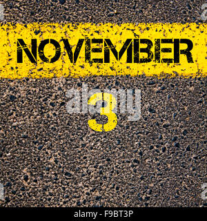 3 November calendar day written over road marking yellow paint line Stock Photo