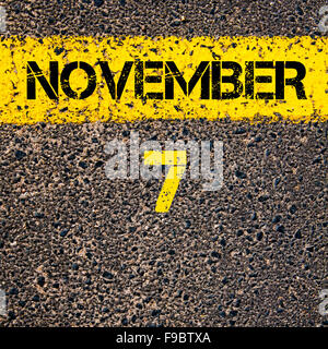 7 November calendar day written over road marking yellow paint line Stock Photo