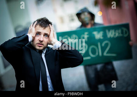 Business man is scared of the end of the world Stock Photo