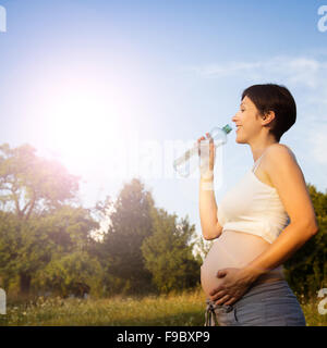 young pregnant woman drinking water Stock Photo - Alamy