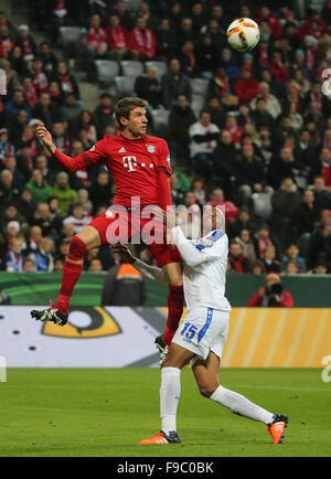 Munich, Germany. 15th Dec, 2015. Thomas Mueller (L) of Bayern Munich vies with a player of Darmstadt during the German Cup (DFB Pokal) third round match in Munich, Germany, Dec. 15, 2015. Bayern Munich won 1-0. © Philippe Ruiz/Xinhua/Alamy Live News Stock Photo