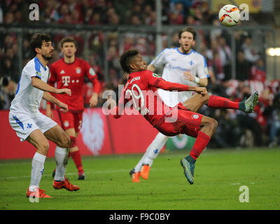 Munich, Germany. 15th Dec, 2015. Kingsley Coman (Front, R) of Bayern Munich jumps to kick the ball during the German Cup (DFB Pokal) third round match against Darmstadt in Munich, Germany, Dec. 15, 2015. Bayern Munich won 1-0. © Philippe Ruiz/Xinhua/Alamy Live News Stock Photo