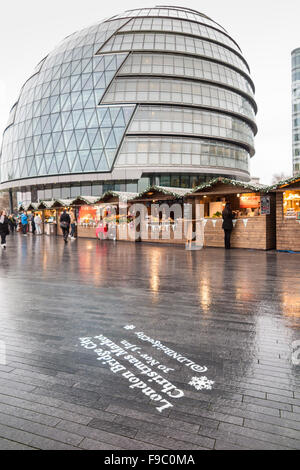 London Bridge City Christmas Market, Southwark, London SE1, on a wet day with City Hall in the background Stock Photo