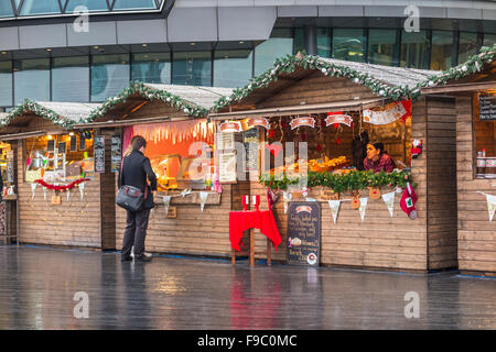 Stall selling Russian pies at London Bridge City Christmas Market, Southwark, London SE1, on a wet day Stock Photo