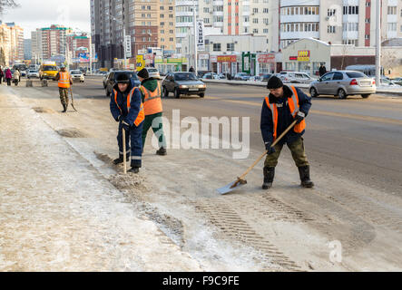 Russian snow clearer teams work on clearing snow from a busy road in the city of Ufa, Russia Stock Photo