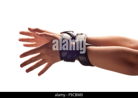 Hands of woman are tied up by belt. Stock Photo