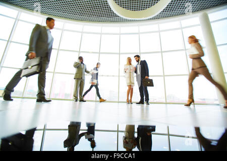 Business people interacting in modern office Stock Photo