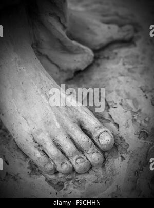 Detail of a marble statue, depicting the foot of the suffering Christ Stock Photo