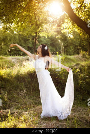 Portrait of beautiful bride in white wedding dress at the meadow Stock Photo