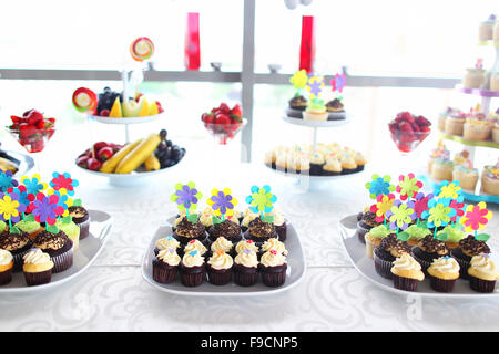 Delicious sweets in a candy bar on wedding table Stock Photo