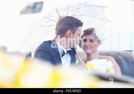 Bride and groom in a vintage car Stock Photo