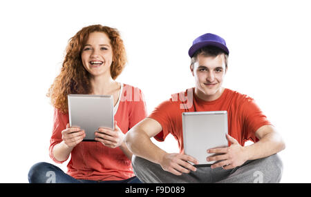 Beautiful young woman and man with tablet in studio Stock Photo