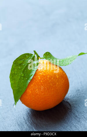 Fresh mandarin on black stone Stock Photo