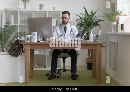 Thoughtful doctor holding chest and lungs xray in medical office Stock Photo