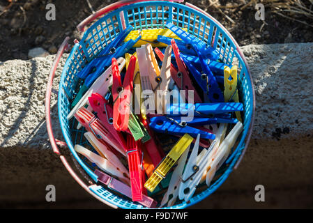 the colored plastic clothespins in a basket Stock Photo