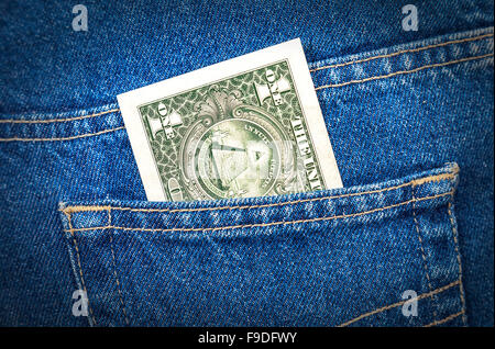 One dollar bill sticking out of the blue jeans pocket Stock Photo