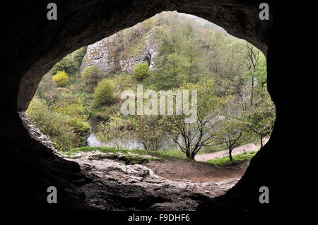 View from inside the 'Dove Holes' a cave beside the river Dove in Dovedale, Peak District, Derbyshire, England. Stock Photo