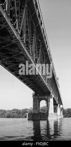 Steel truss bridge over Danube river between Bulgaria and Romania, black and white photo Stock Photo