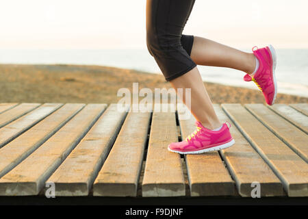 Young woman is running in sunny nature Stock Photo